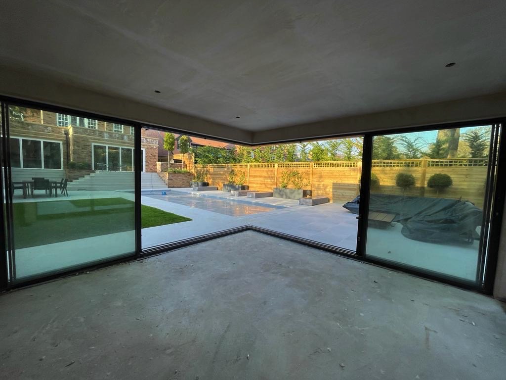 open corner sliding doors in a modern extension with garden and patio views. 