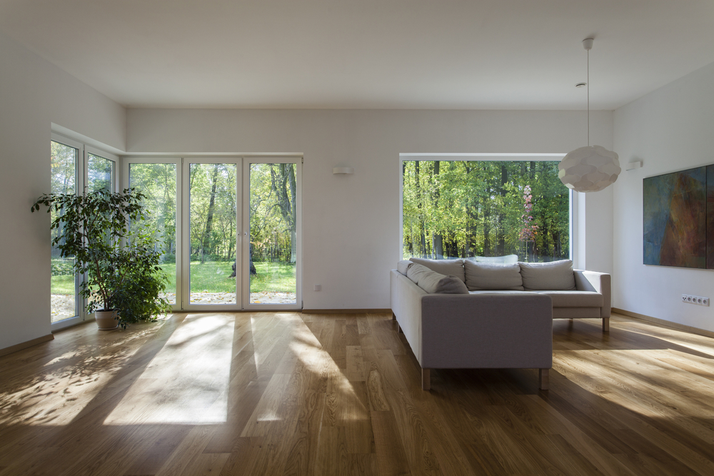 sheerline bifold doors in a lounge setting, cream colour with matching window