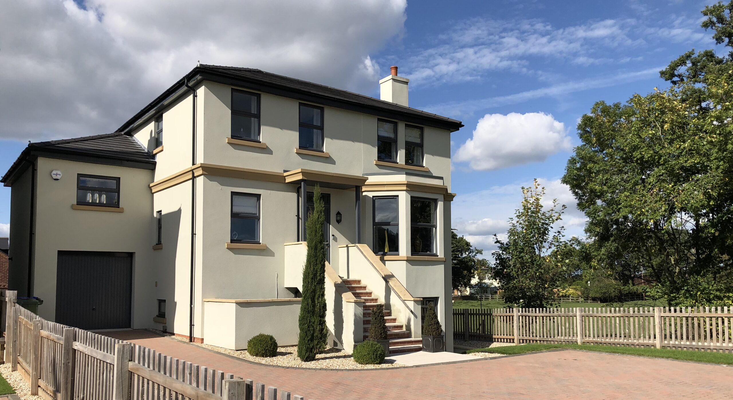 grey liniar PVCu windows in a mock georgian new build house