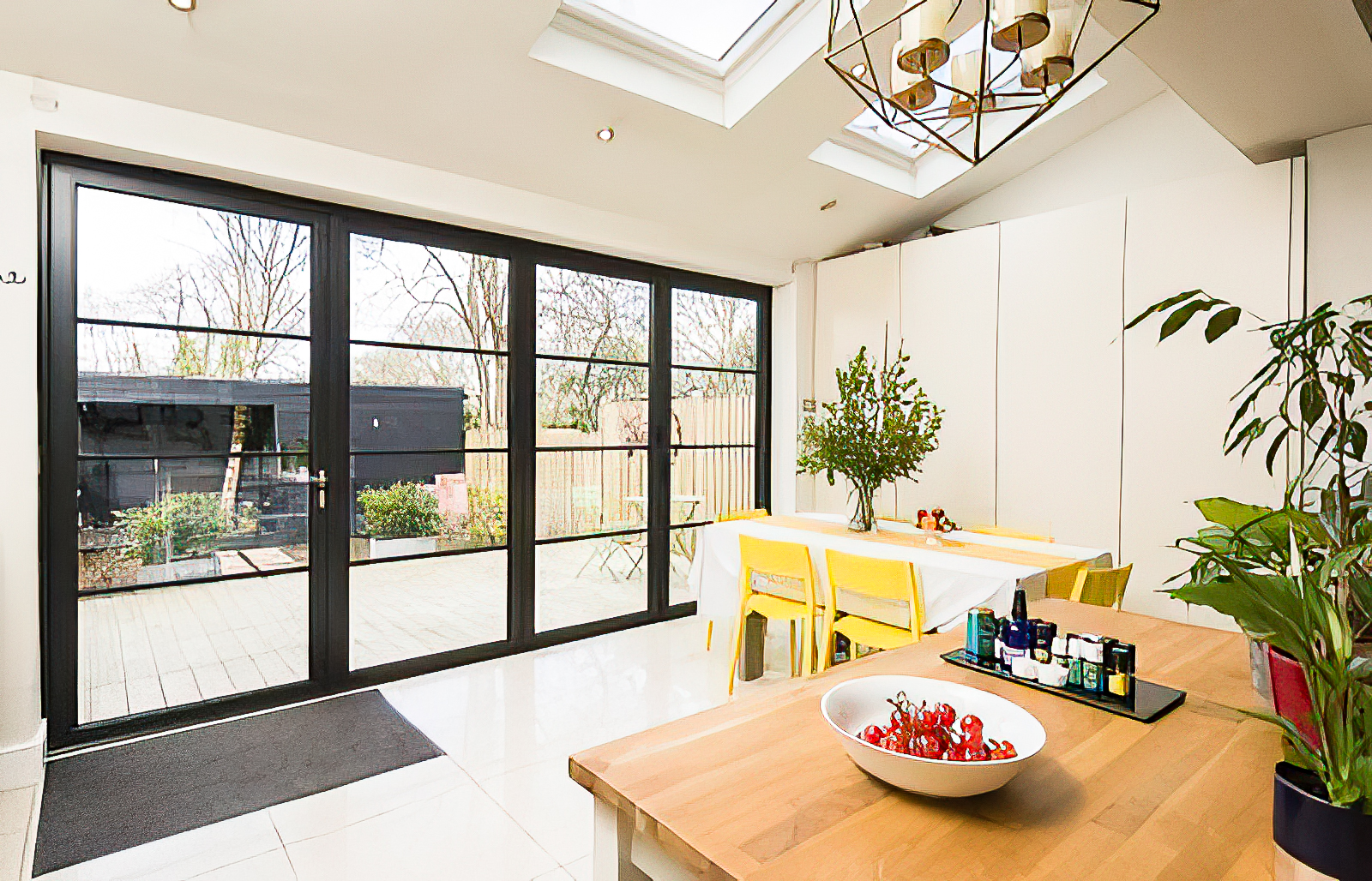 steel look bifold doors in a kitchen extension with rooflight above