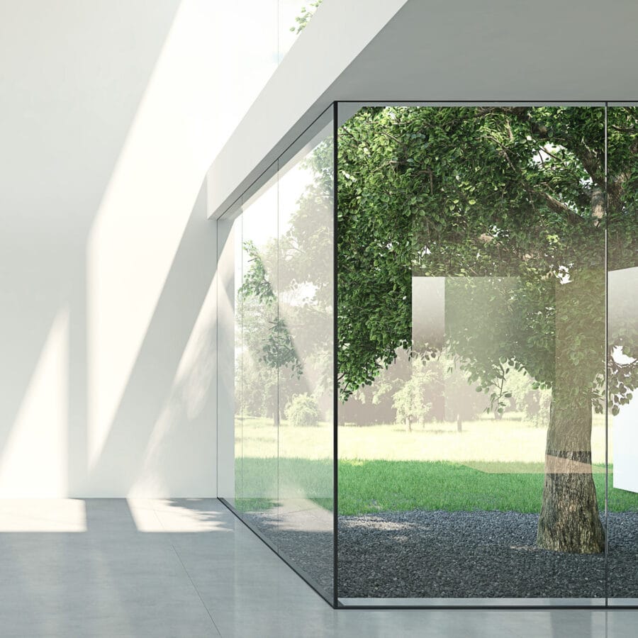 frameless box window in an empty room with garden view